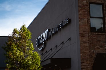 New Year, New Amazon Size Tier and Fee Changes Amazon building with tree